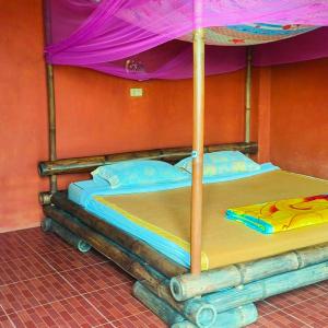 a bedroom with a bunk bed with an umbrella at Akha Hill House in Ban Doi Hang