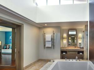 a bathroom with a tub and a sink at Pullman Phuket Panwa Beach Resort in Panwa Beach