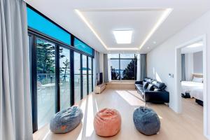 a living room with a couch and some large rocks at The Bay Jeju Resort in Seogwipo +52 photos