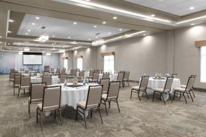 a conference room with tables and chairs and a screen at Hilton Garden Inn Topeka in Topeka +35 photos