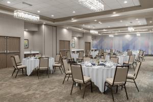 a conference room with white tables and chairs at Hilton Garden Inn Topeka in Topeka