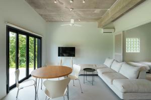 a living room with a couch and a table at Palm Hills in Ishigaki Island