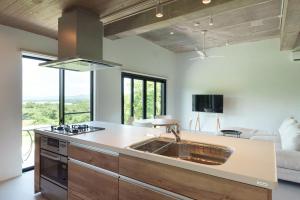 a kitchen with a sink and a living room at Palm Hills in Ishigaki Island +61 photos