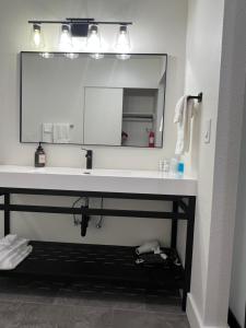 a bathroom with a sink and a large mirror at Lake Shastina Golf Resort in Weed