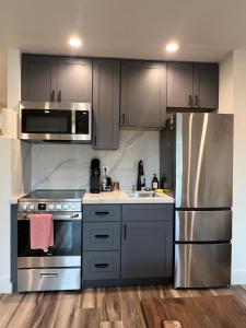 a kitchen with gray cabinets and a stainless steel refrigerator at Lake Shastina Golf Resort in Weed +78 photos