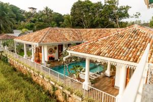an aerial view of a house with a swimming pool at ISOLA - Surf House in Ahangama