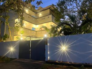 a white house with a gate and a fence at Villa The De Grise in Pondicherry