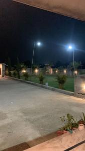 a parking lot at night with two street lights at Happy Homes in Jammu +22 photos