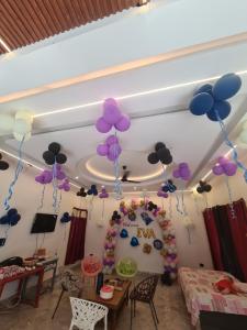 a room with balloons hanging from the ceiling at Happy Homes in Jammu