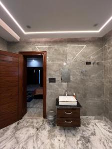 a bathroom with a sink and a shower at Happy Homes in Jammu
