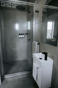 a bathroom with a shower and a white sink at Rix Hotel Motel in Charters Towers +78 photos