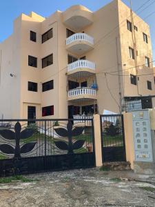 a building with a fence in front of it at Condominio cortico in Mendoza