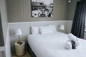 a bedroom with a large white bed and a window at Rix Hotel Motel in Charters Towers