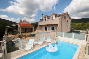 a villa with a swimming pool and swans on it at VILLA DINJA in Gizdavac