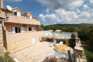 a villa with a patio and a swimming pool at VILLA DINJA in Gizdavac