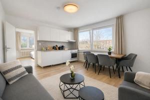 a living room with a couch and a table at Emden City Center - Innenstadt in Emden