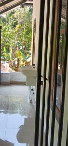 a bathroom with a sink and a window at Quiet Canopy homestay in Padinjarathara