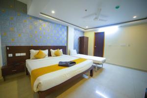 a hotel room with a bed with a bag on it at Sri Saai Surguru Residency in Pondicherry