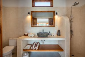 a bathroom with a sink and a mirror at LYS Home in Jimbaran +24 photos