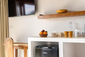 a kitchen with a counter with a microwave at LYS Home in Jimbaran