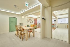 a kitchen and dining room with a table and chairs at The FLOW HOUSE in Suwon