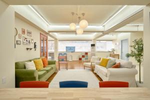 a living room with two couches and a table at The FLOW HOUSE in Suwon