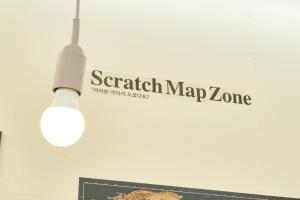 a light hanging from a wall with the words search map zone at The FLOW HOUSE in Suwon