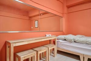 a room with two beds and a mirror at The FLOW HOUSE in Suwon