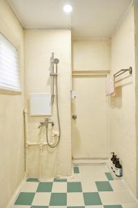 a bathroom with a shower and a checkered floor at The FLOW HOUSE in Suwon +45 photos