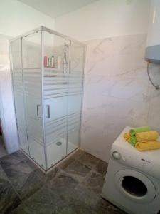 a shower stall in a bathroom with a toilet at House Veli Iz oldtown in Veli Iž +17 photos