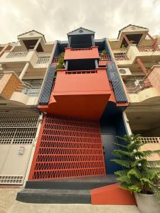 a building with orange and blue paint on it at TERREST MAISON On Nut in Bangkok