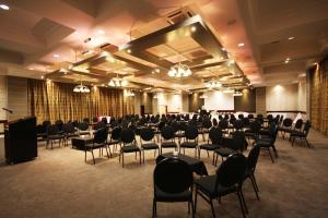 a banquet hall with chairs and a podium in a room at Hotel Osner in East London +27 photos