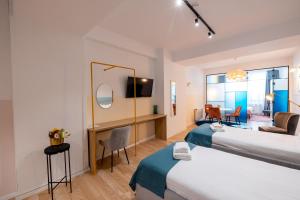 a hotel room with two beds and a living room at Stil Old Town Boutique Hotel in Bucharest