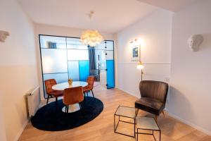a living room with a table and chairs at Stil Old Town Boutique Hotel in Bucharest