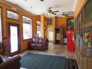 a living room with a couch and a red refrigerator at Main Street Inn in Lowell