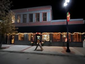 a building with christmas lights in front of it at Main Street Inn in Lowell