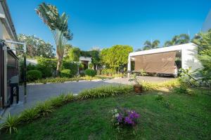 a large tent in a yard next to a street at 3BR Pool Green Park Villa near Rawai Beach in Ban Saiyuan (1)
