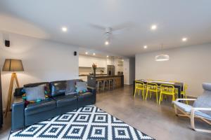 a living room with a couch and a table and chairs at The Bright House in Bendigo
