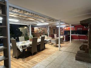 a dining room and kitchen with a table and chairs at Le coin des romarins in Saint-André +25 photos