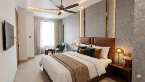 a bedroom with a large bed with a ceiling fan at Hotel Krone International in Gurgaon