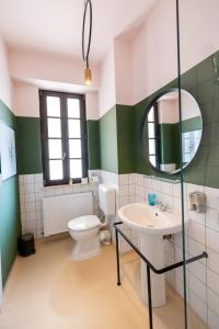 a bathroom with a toilet and a sink and a mirror at Stil Old Town Boutique Hotel in Bucharest +79 photos