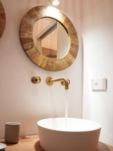 a bathroom with a white sink and a mirror at Maison Begani66 in Gaeta