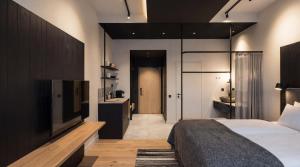 a bedroom with a bed and a flat screen tv at Santa's Hotel Noelle in Rovaniemi