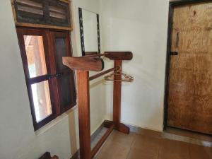 a wooden cross in a room with a window at Mama Washindi Lodge in Pakwach East