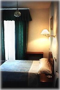 a bedroom with a bed and a window at Hostal Rivera - Atocha in Madrid