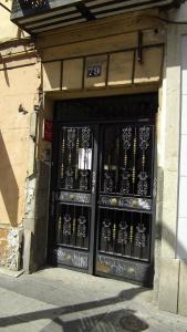 un edificio con puertas negras con escritura china. en Hostal Rivera - Atocha en Madrid