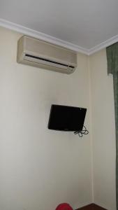a room with a fan and a tv on the wall at Hostal Rivera - Atocha in Madrid