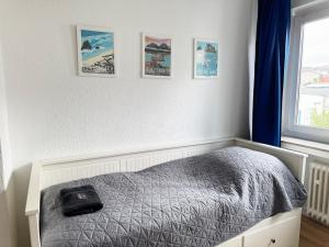 a bedroom with a bed and pictures on the wall at 3 Zimmer Apartment mit Garten in Wuppertal