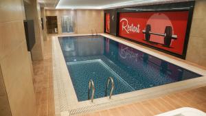 a large swimming pool in a building at فندق البرج الابيض - White Tower Hotel in Ōlmush