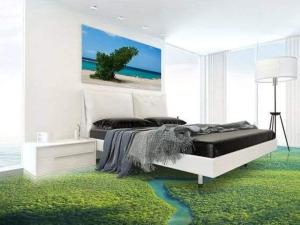 a bedroom with a bed with a green rug at ROYALrest HOTELS in Elele